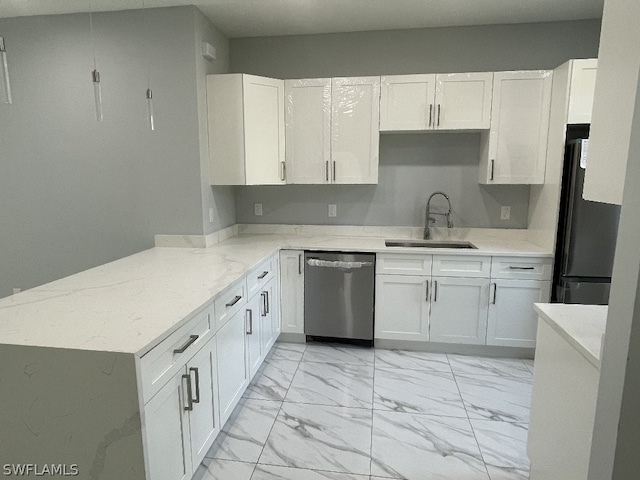 kitchen with white cabinetry, dishwasher, black fridge, and sink