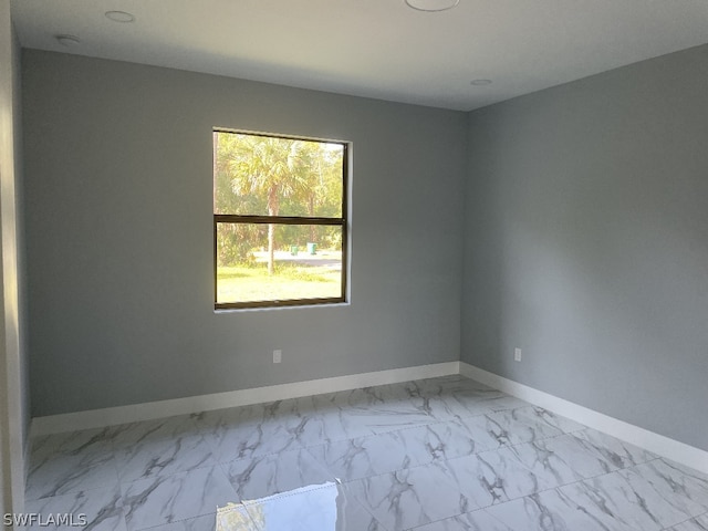 spare room featuring light tile floors