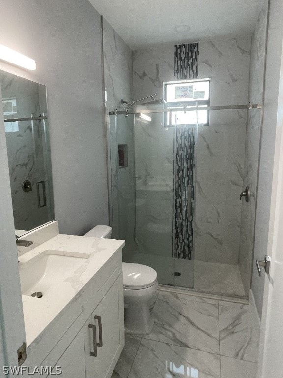 bathroom featuring vanity with extensive cabinet space, an enclosed shower, toilet, and tile flooring