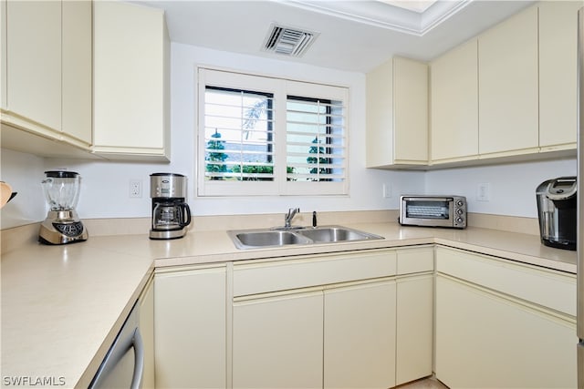 kitchen featuring cream cabinets and sink