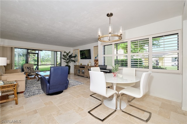 dining room featuring plenty of natural light and a notable chandelier