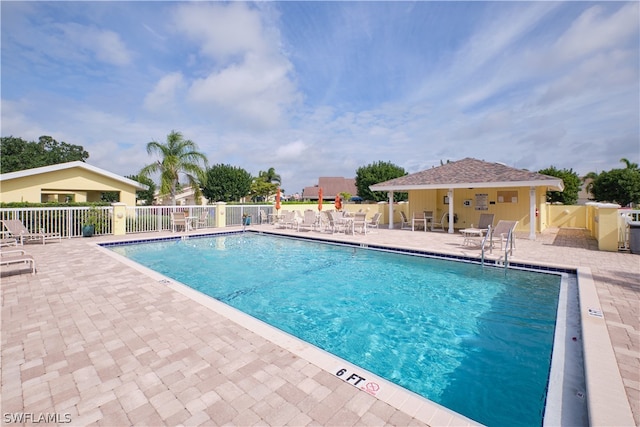 view of pool with a patio area and an outdoor structure