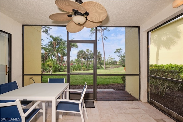 sunroom / solarium featuring ceiling fan