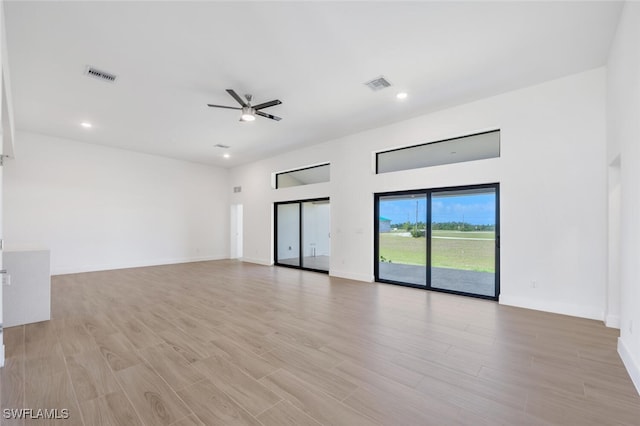 unfurnished living room with ceiling fan and light hardwood / wood-style floors