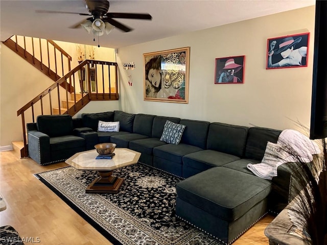 living room featuring ceiling fan and light hardwood / wood-style flooring