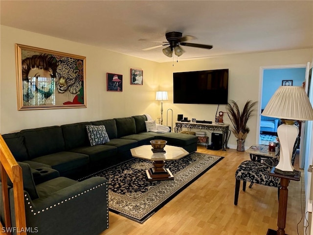 living room featuring ceiling fan and light hardwood / wood-style flooring