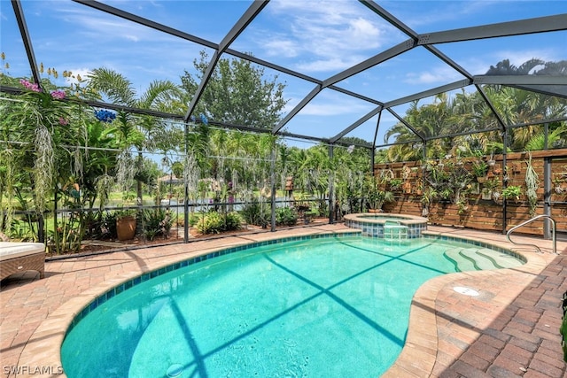 view of pool featuring an in ground hot tub, a patio area, and a lanai