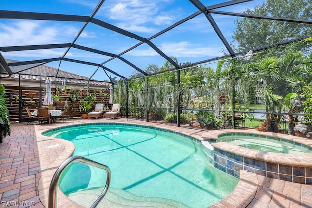 view of swimming pool featuring glass enclosure, a patio area, and an in ground hot tub