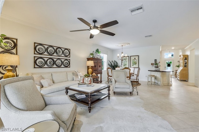 living room with ceiling fan with notable chandelier, light tile patterned floors, and crown molding