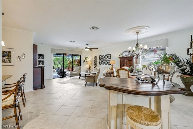 dining room with crown molding, light tile patterned flooring, and ceiling fan with notable chandelier