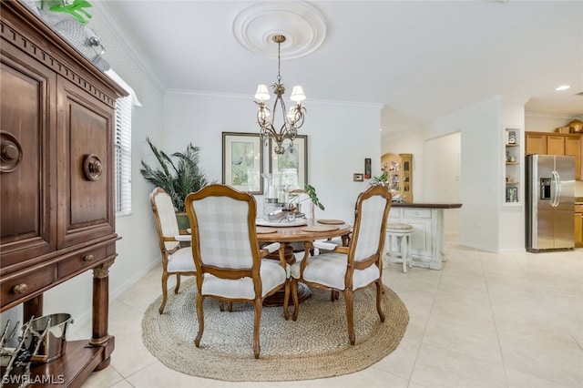 dining room with a notable chandelier, ornamental molding, and light tile patterned floors