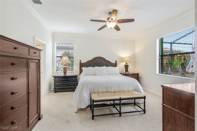 carpeted bedroom with ceiling fan and ornamental molding