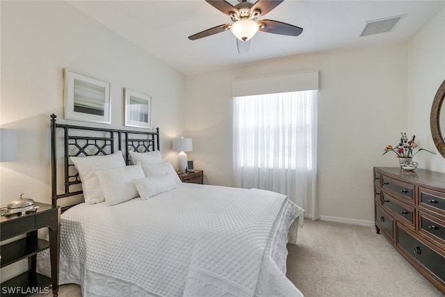 bedroom with ceiling fan and light colored carpet