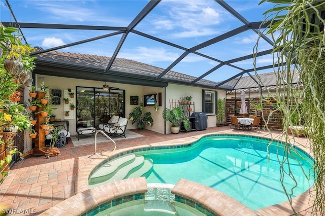 view of swimming pool with ceiling fan, area for grilling, a lanai, and a patio