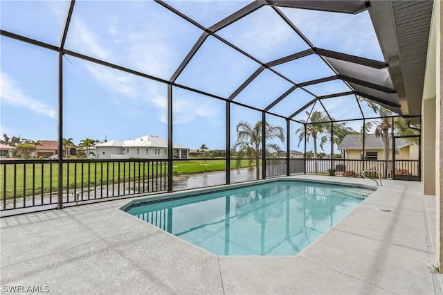 view of swimming pool featuring glass enclosure, a yard, and a patio