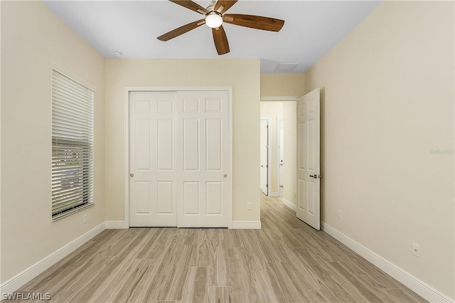 unfurnished bedroom featuring light hardwood / wood-style flooring, a closet, and ceiling fan