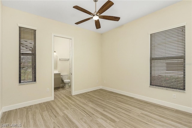 spare room with ceiling fan and light wood-type flooring