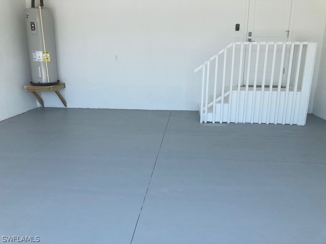 interior space with concrete floors and electric water heater