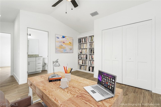 dining room with wood-type flooring, lofted ceiling, and ceiling fan