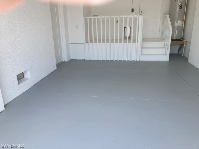 interior space with concrete floors and electric water heater