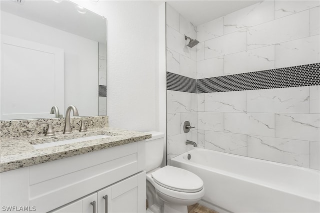 full bathroom featuring tiled shower / bath combo, oversized vanity, and toilet