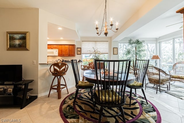 dining space featuring light tile patterned floors and a chandelier