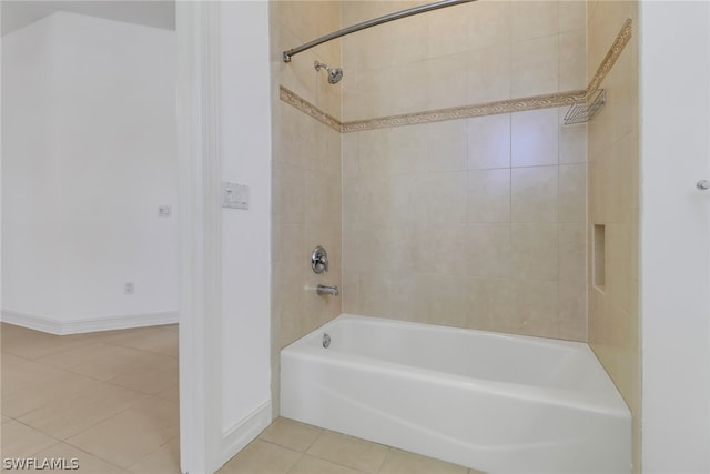 bathroom featuring tile flooring and tiled shower / bath