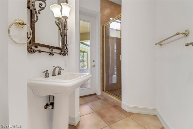 bathroom with tile flooring and a shower with door