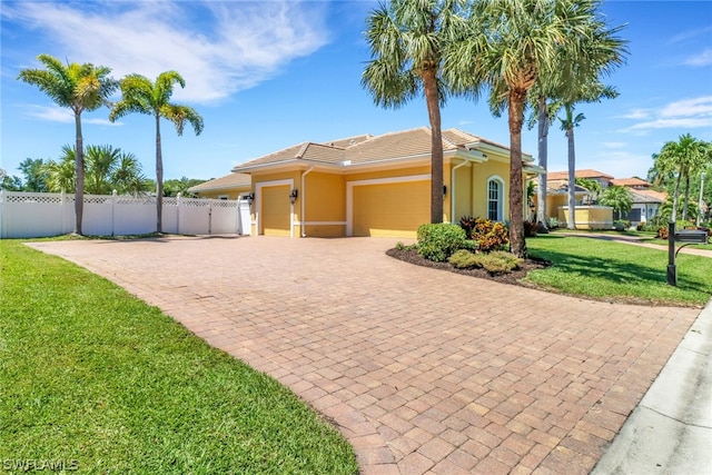 view of front of property with a front lawn and a garage