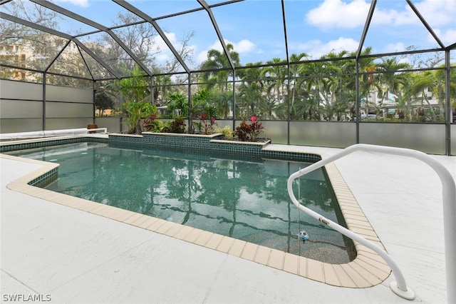 view of swimming pool featuring glass enclosure and a patio