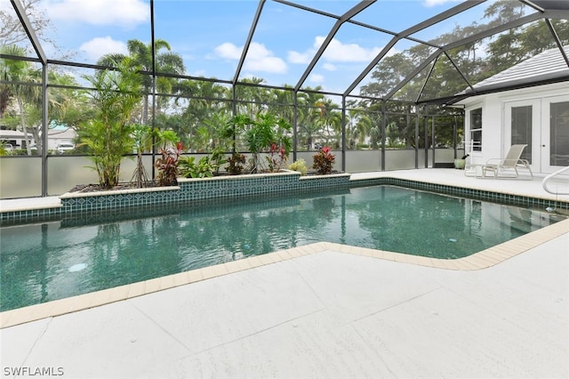 view of swimming pool featuring a patio, a lanai, and french doors