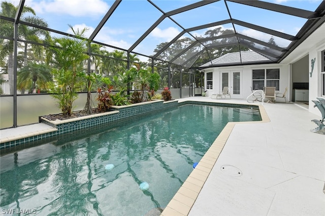 view of pool featuring a patio and glass enclosure