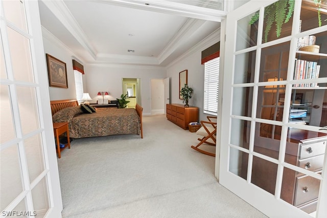 bedroom featuring french doors, light colored carpet, and a tray ceiling