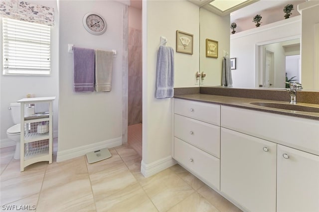 bathroom with toilet, tile floors, and vanity