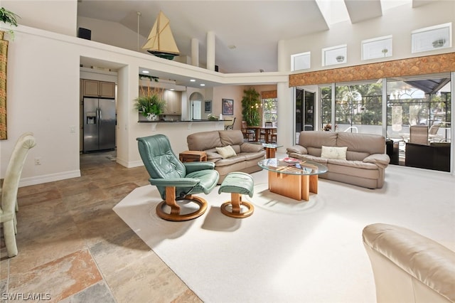 living room with tile floors and high vaulted ceiling