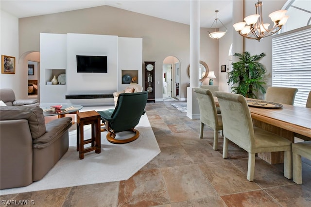 living room featuring high vaulted ceiling, an inviting chandelier, and light tile flooring