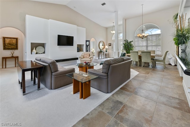 tiled living room featuring an inviting chandelier and high vaulted ceiling