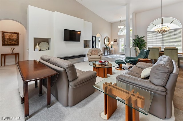 living room with a chandelier and high vaulted ceiling