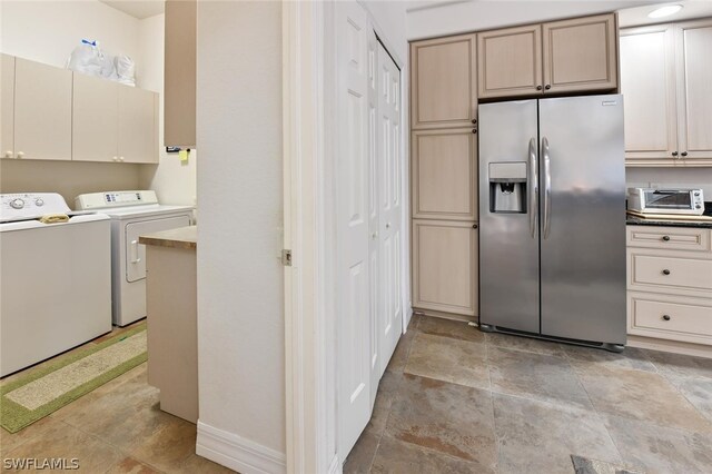 kitchen featuring washing machine and clothes dryer, light tile flooring, and stainless steel refrigerator with ice dispenser