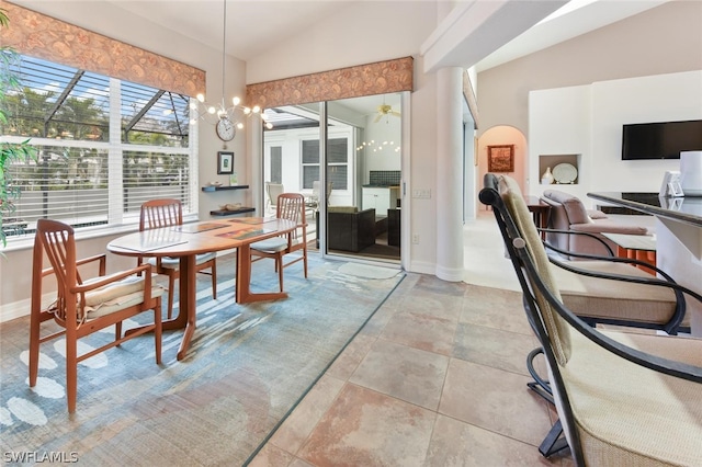 dining room featuring lofted ceiling, light tile floors, and an inviting chandelier