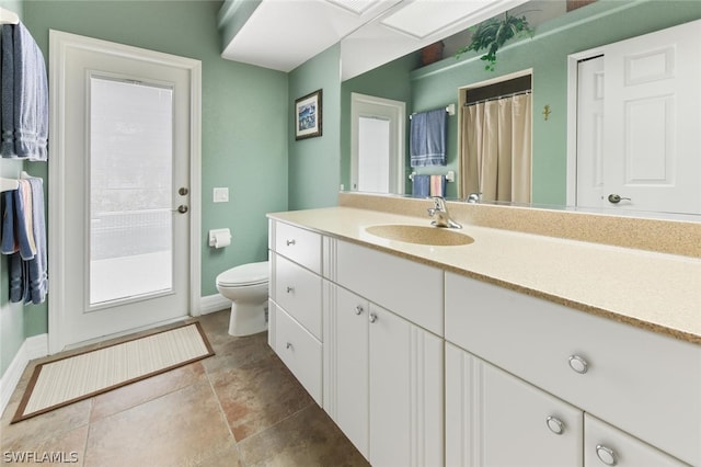 bathroom with tile flooring, toilet, and oversized vanity