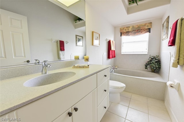 bathroom featuring toilet, tile floors, large vanity, and tiled tub