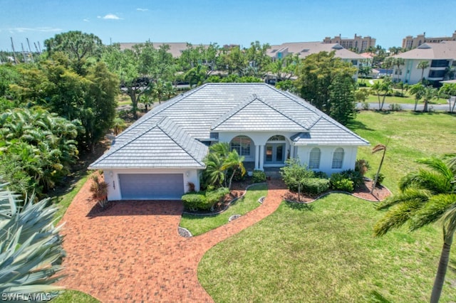 view of front of property with a front lawn and a garage