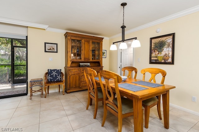 dining space featuring crown molding and light tile floors