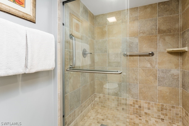 bathroom with walk in shower and toilet