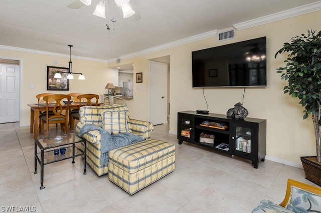 tiled living room with crown molding and ceiling fan with notable chandelier