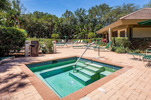 view of pool with a community hot tub and a patio area