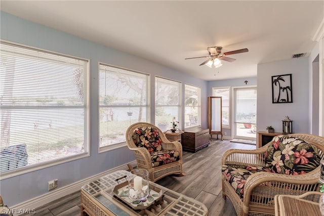 living room with ceiling fan and hardwood / wood-style flooring