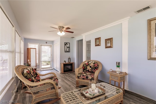 living room with dark hardwood / wood-style flooring and ceiling fan