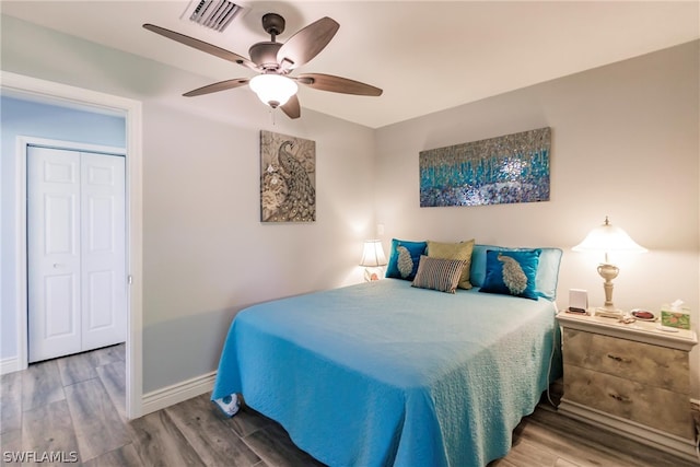 bedroom featuring a closet, wood-type flooring, and ceiling fan